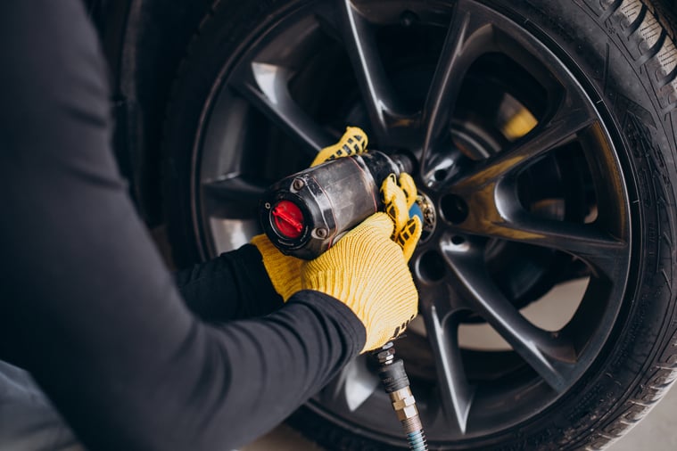 car-mechanic-changing-wheels-in-car